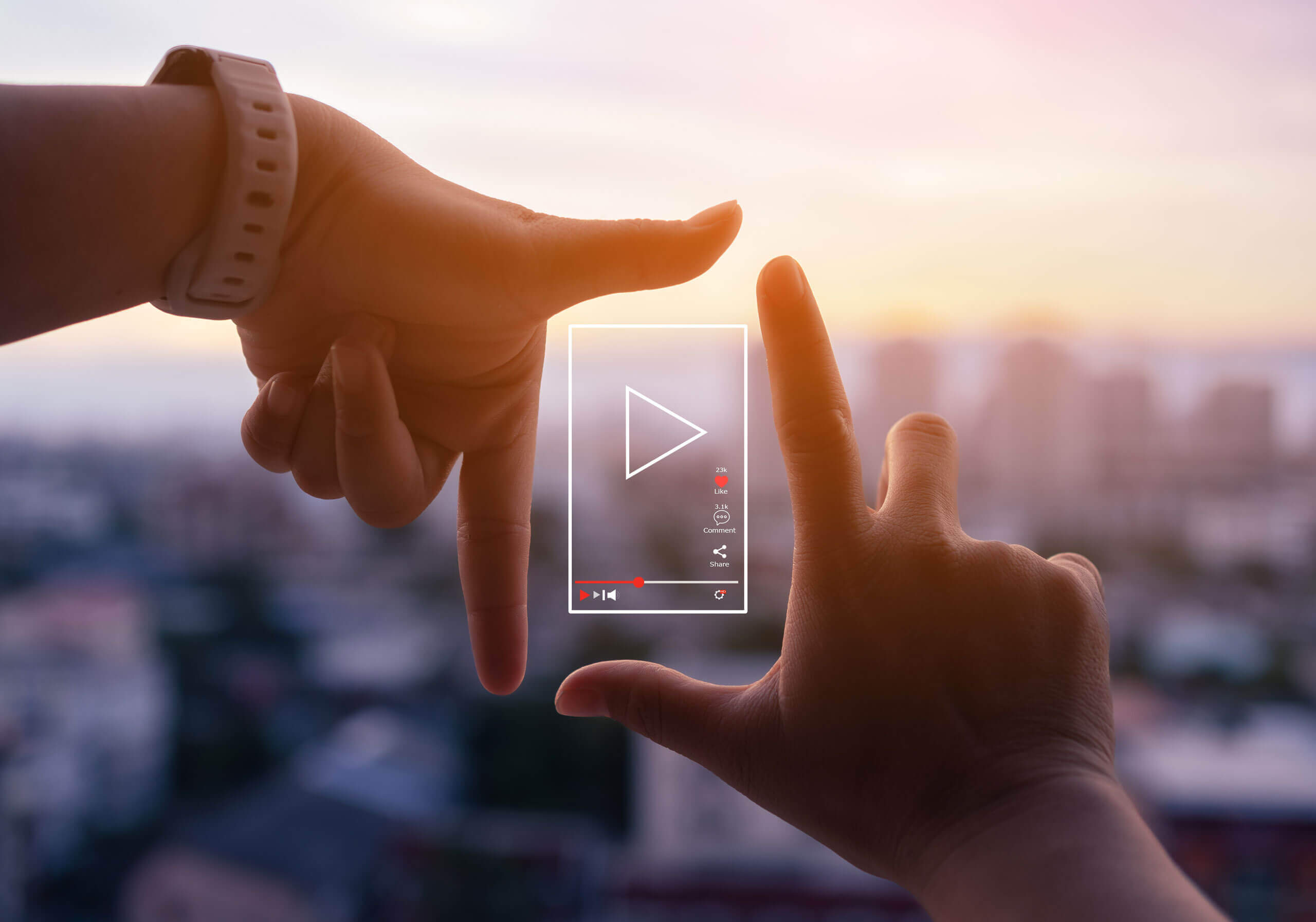 Hands outlining a social media video silhouette with a city in the background